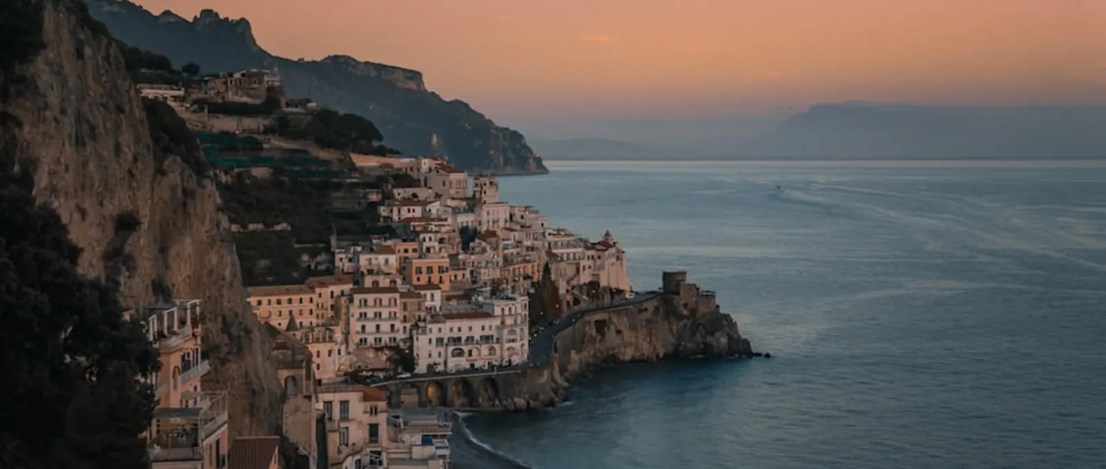 The town of Amalfi on its cliff, late in the day.