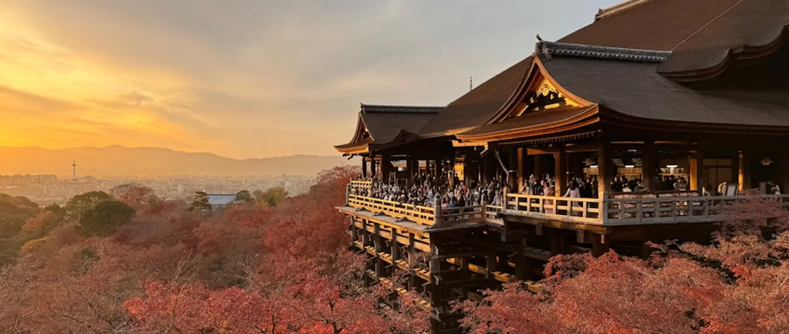 A temple above Kyoto at sunset, in autumn colour.