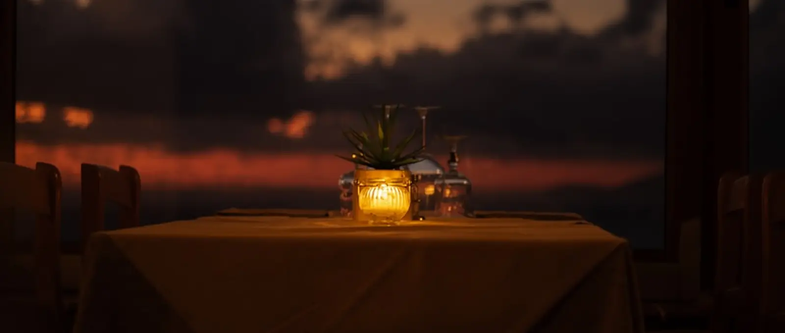 A table laid for dinner as the light goes.